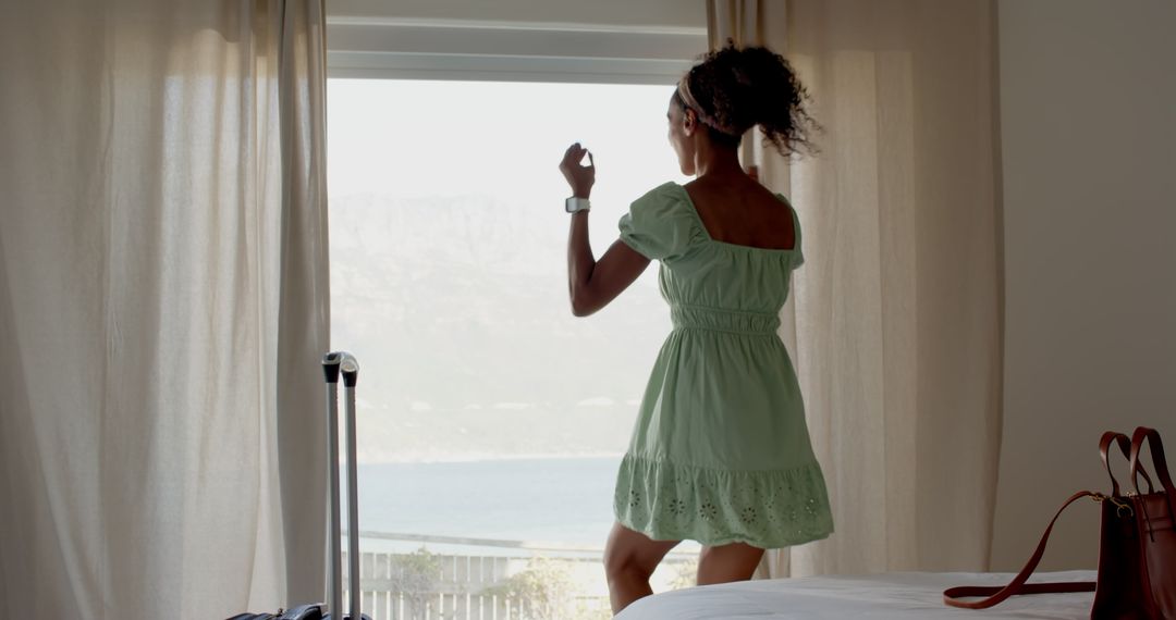 Woman Enjoying Seaside View From Vacation Room