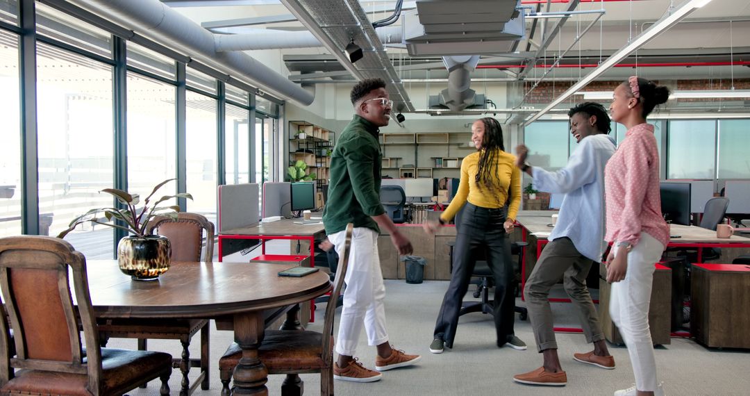 Diverse Team Celebrating Success in Lively Modern Office Environment