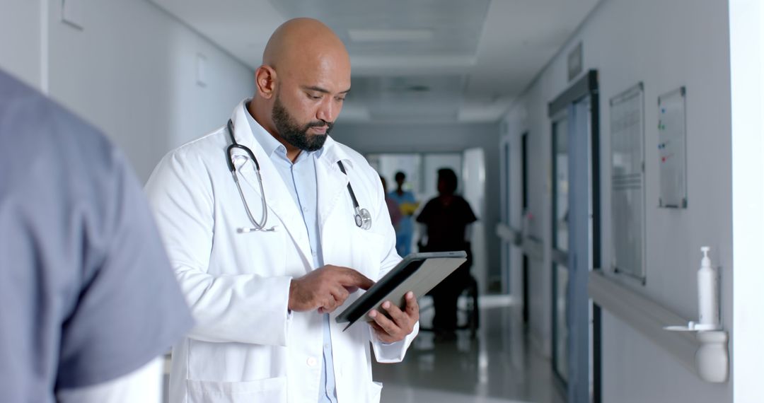 Doctor Using Tablet in Hospital Corridor - Free Images, Stock Photos and Pictures on Pikwizard.com