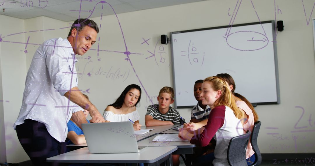 Teacher Explaining Math to Attentive Students Using Laptop