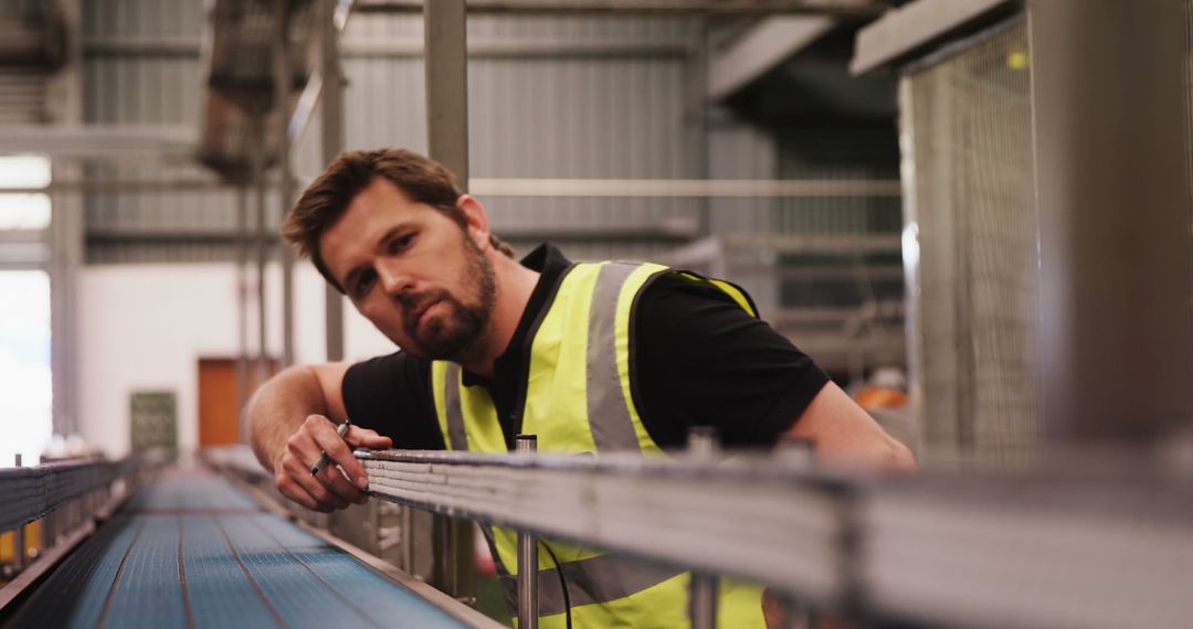 Engineer Inspecting Conveyor Belt in Manufacturing Plant - Free Images, Stock Photos and Pictures on Pikwizard.com