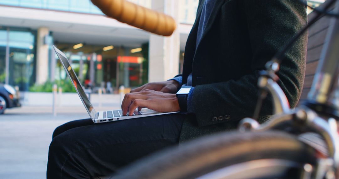 Businessman Working Outdoors on Laptop Near Bicycle - Free Images, Stock Photos and Pictures on Pikwizard.com