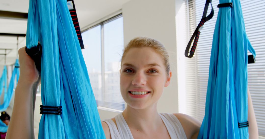 Smiling Woman Holding Aerial Yoga Silks in Bright Studio - Free Images, Stock Photos and Pictures on Pikwizard.com