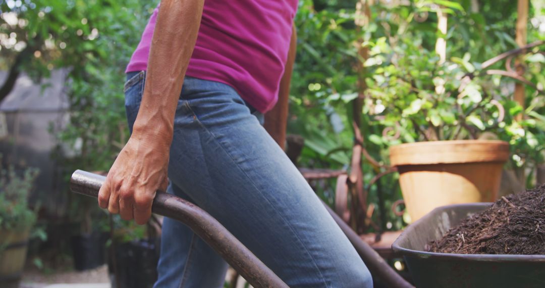 Caucasian Woman Gardening with Wheelbarrow in Sunny Garden - Free Images, Stock Photos and Pictures on Pikwizard.com