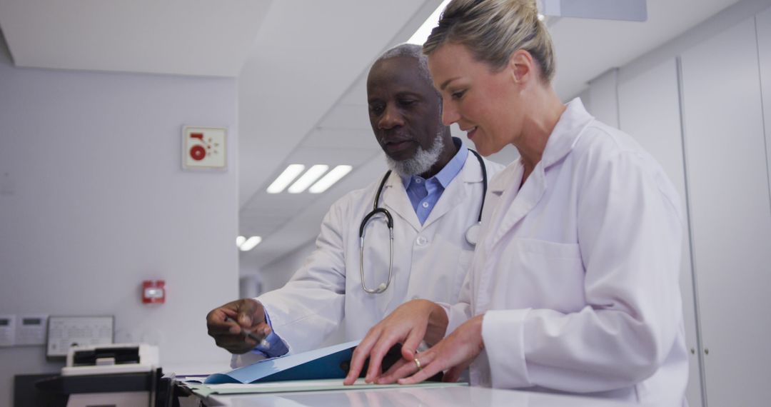 Two Medical Professionals Reviewing Patient Files in Hospital - Free Images, Stock Photos and Pictures on Pikwizard.com