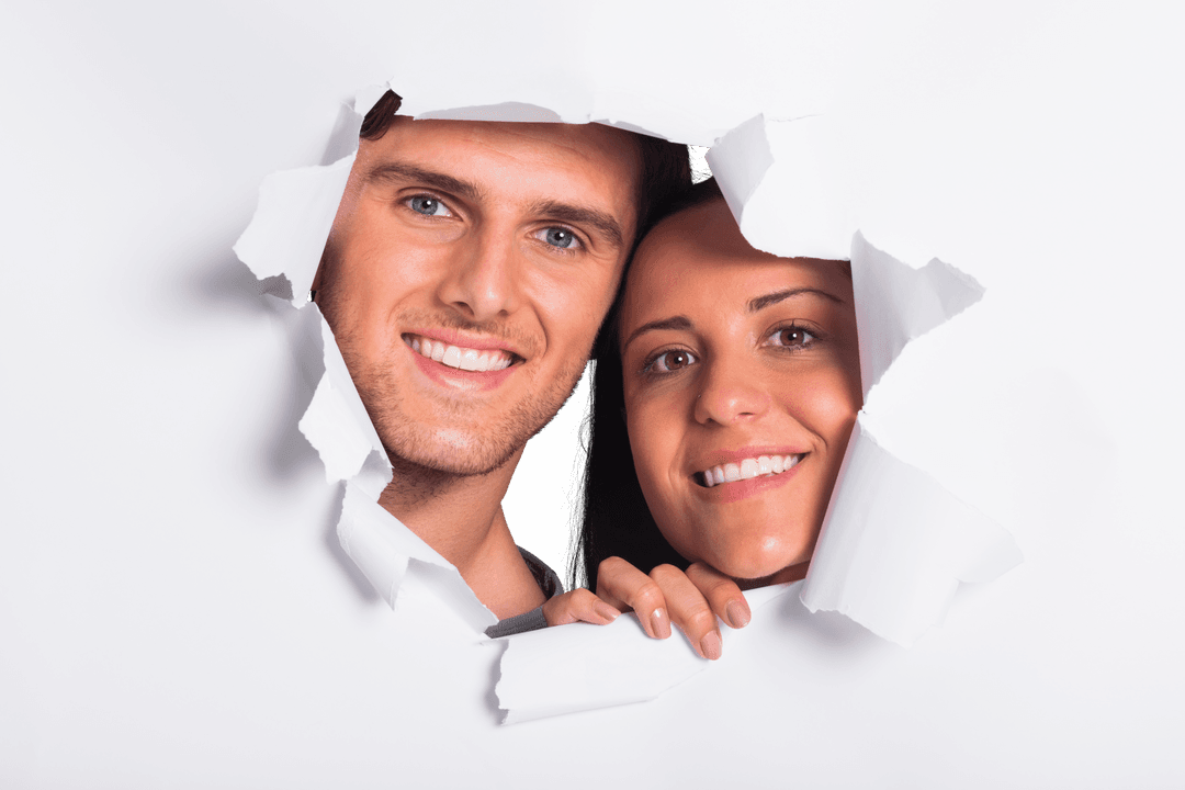 Young Couple Smiling Through Torn Paper for Transparent Art