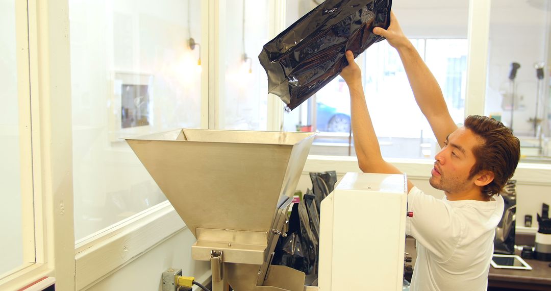 Worker Operating Coffee Sealing Machine in Busy Shop