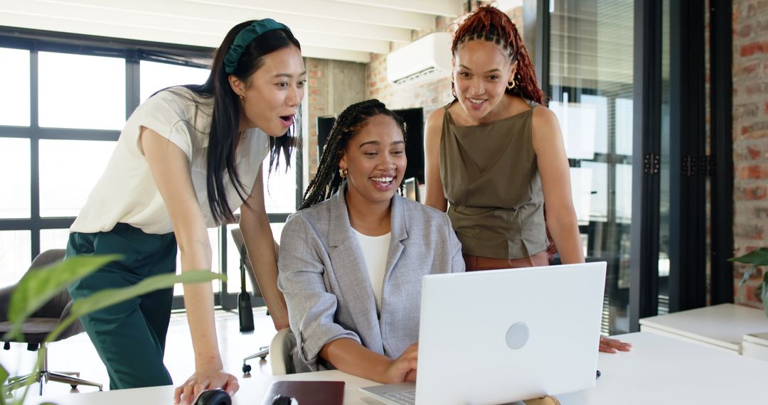Diverse Female Team Collaborating with Enthusiasm in Modern Office