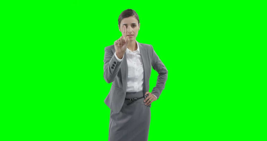 Businesswoman Using Touchscreen Gesture on Green Background, Professional Office Attire - Free Images, Stock Photos and Pictures on Pikwizard.com