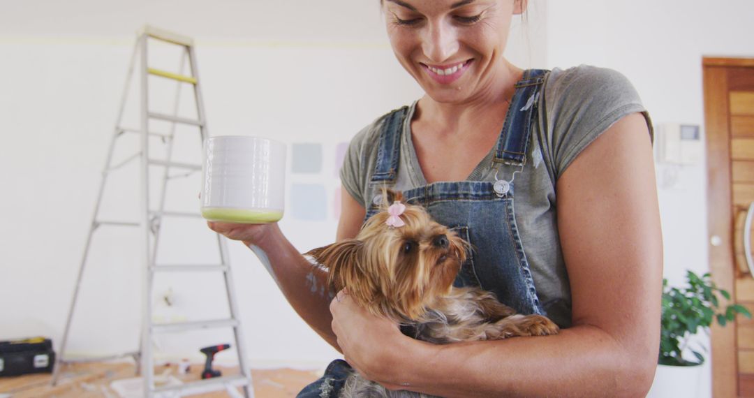 Woman Holding Yorkshire Terrier While Taking a Break From Home Renovation - Free Images, Stock Photos and Pictures on Pikwizard.com