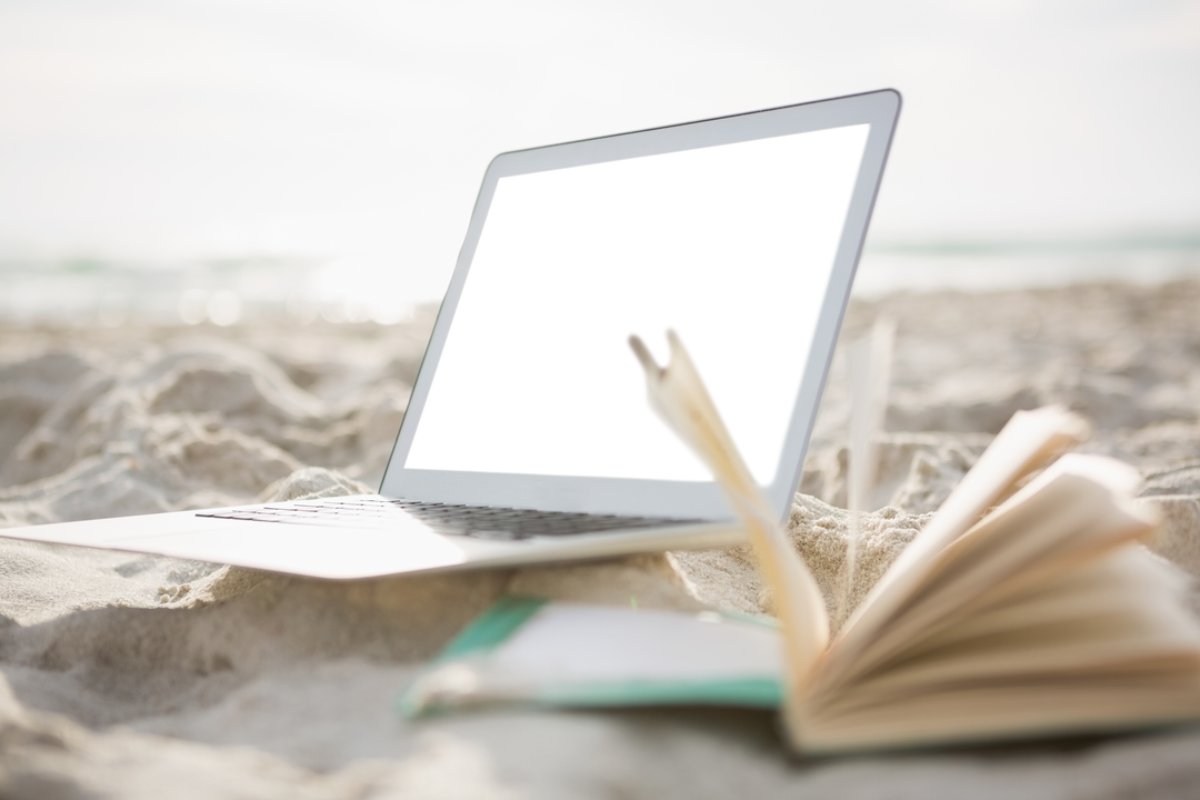 Transparent Laptop Screen and Open Book on Beach Sand - Download Free Stock Images Pikwizard.com