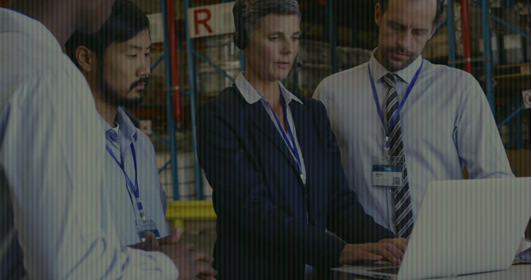 Warehouse Team Collaborating with Laptop and Inventory for Effective Management