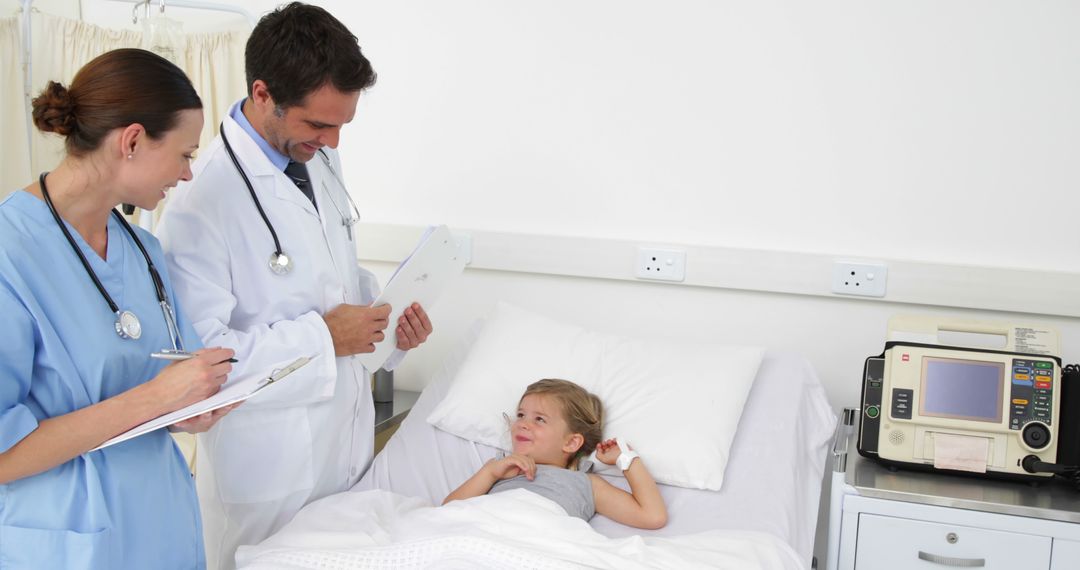 Doctors Providing Medical Care to Child in Hospital Bed - Free Images, Stock Photos and Pictures on Pikwizard.com