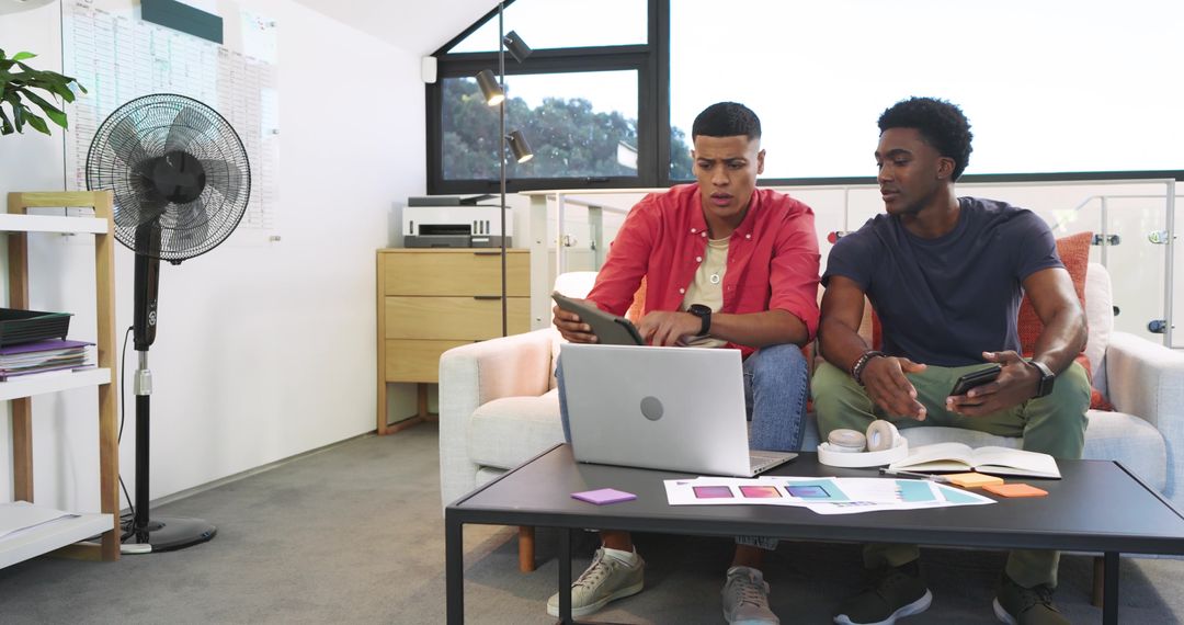 Diverse Team Collaborating Over Digital Devices in Modern Office