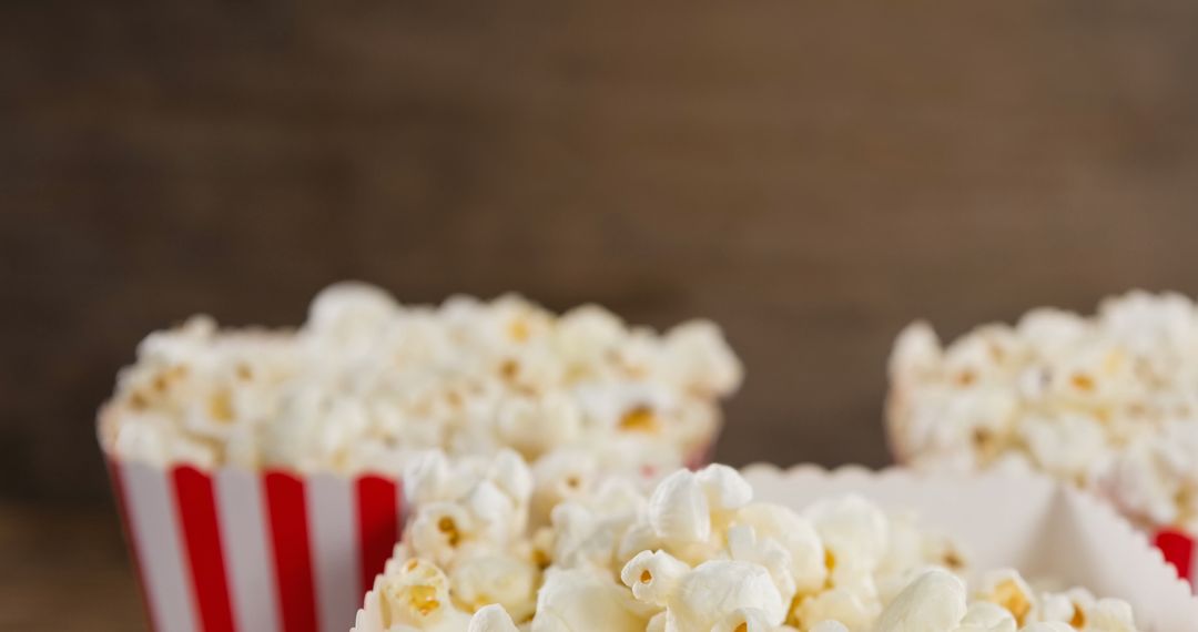 Fresh Popcorn in Striped Boxes on Wooden Background - Free Images, Stock Photos and Pictures on Pikwizard.com