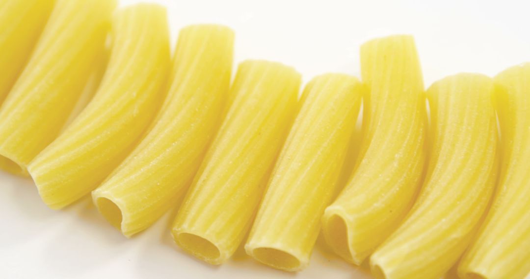 Close-Up of Dry Uncooked Pasta Pieces on White Background - Free Images, Stock Photos and Pictures on Pikwizard.com