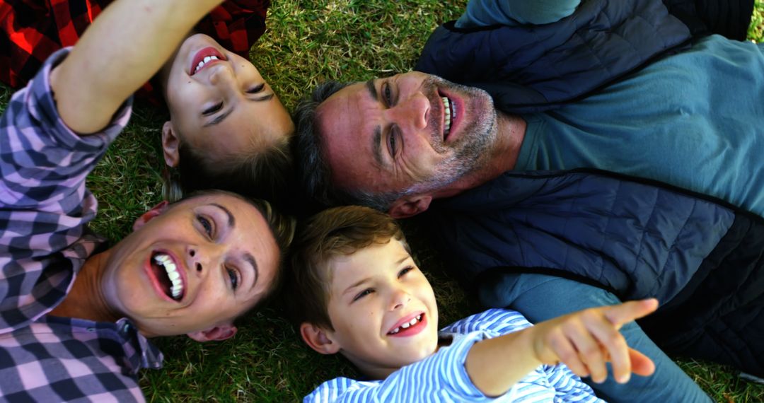 Happy Family Lying on Grass Enjoying Quality Time Together - Free Images, Stock Photos and Pictures on Pikwizard.com