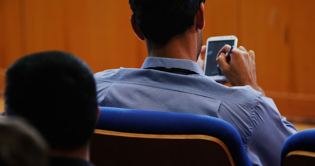 Businessman Checking Smartphone During Meeting - Free Images, Stock Photos and Pictures on Pikwizard.com