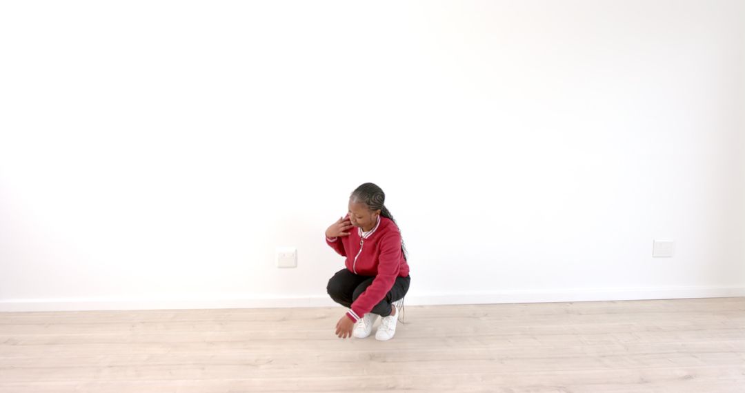 Woman in red hoodie contemplating on wooden floor