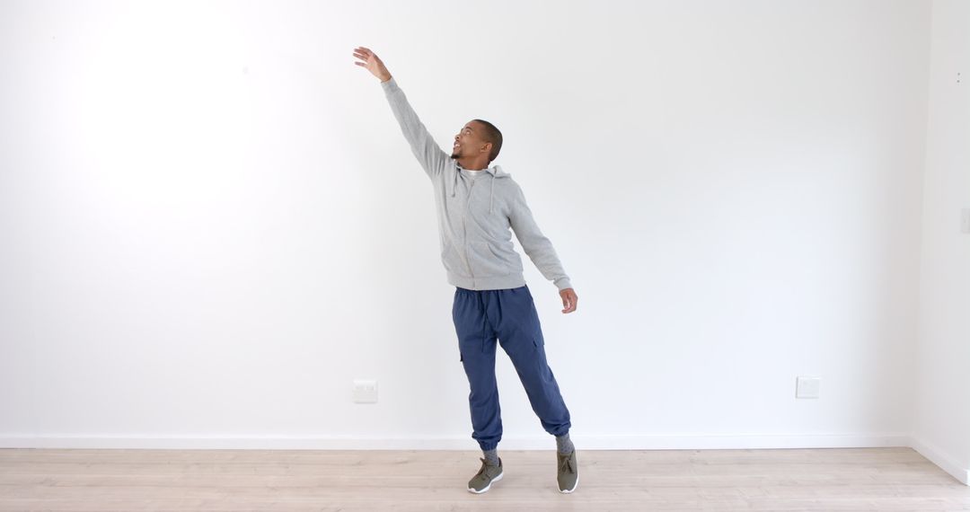 Man Jumping Indoors with Enthusiasm and Determination