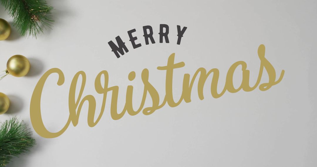Merry Christmas Text with Festive Gold Ornaments and Greenery