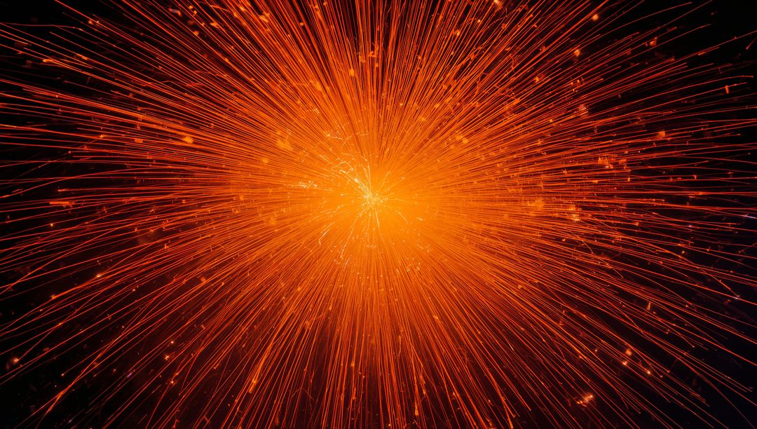 Radiant Orange Sparks Creating Starburst in Darkness