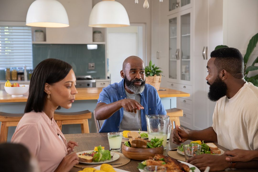 Diverse Family Enjoying Meal Together at Home in Modern Kitchen