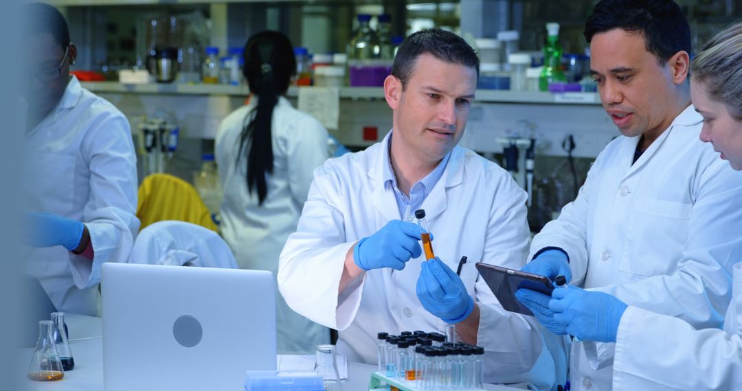 Scientists Collaborating in Lab Analyzing Test Tube and Tablet Data - Free Images, Stock Photos and Pictures on Pikwizard.com