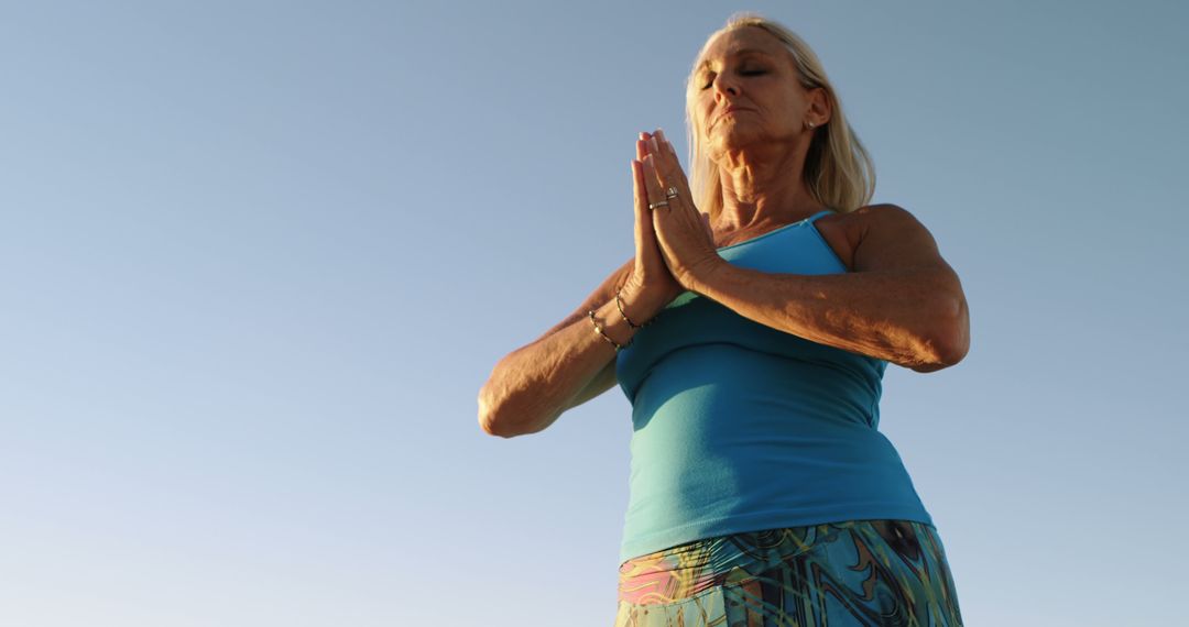 Senior Woman Practicing Yoga Outdoors at Sunrise - Free Images, Stock Photos and Pictures on Pikwizard.com