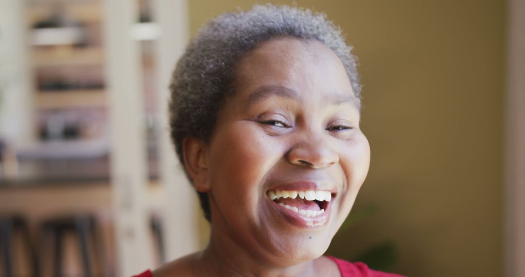 Older African Woman Laughing Joyfully Indoors - Free Images, Stock Photos and Pictures on Pikwizard.com