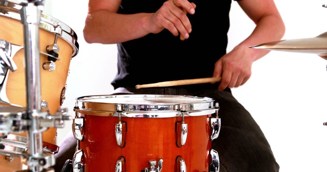 Drummer playing his drum kit on white background - Free Images, Stock Photos and Pictures on Pikwizard.com