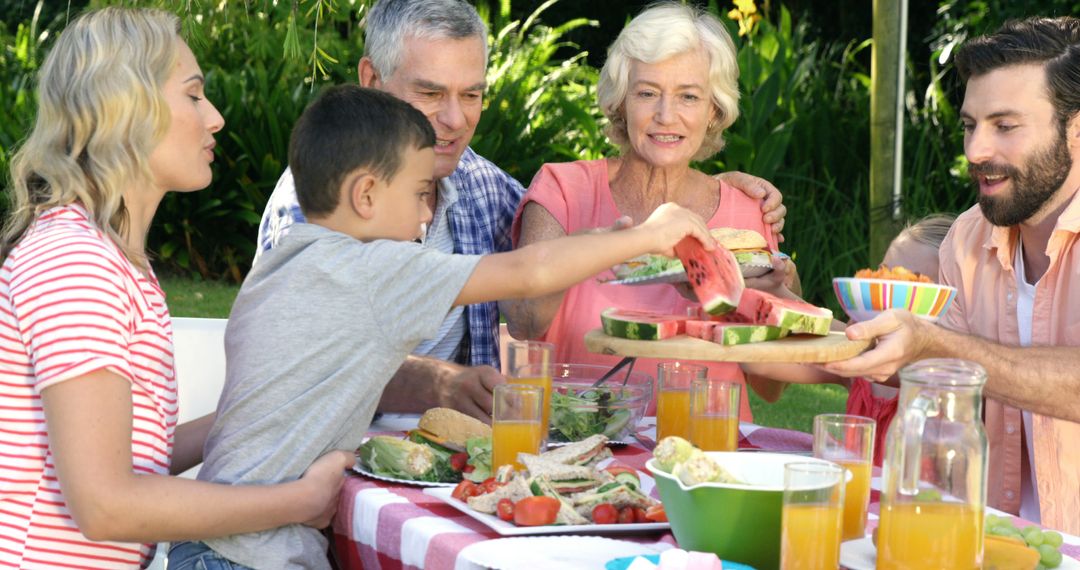 Family Enjoying Outdoor Picnic with Fresh Fruits and Juice - Free Images, Stock Photos and Pictures on Pikwizard.com