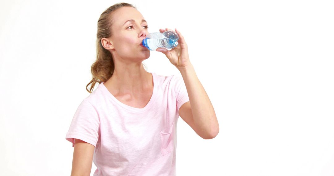 Woman Drinking Bottled Water Hydrating on White Background - Free Images, Stock Photos and Pictures on Pikwizard.com