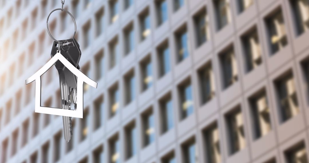 House-Shaped Key Hanging In Front Of Modern Building Facade