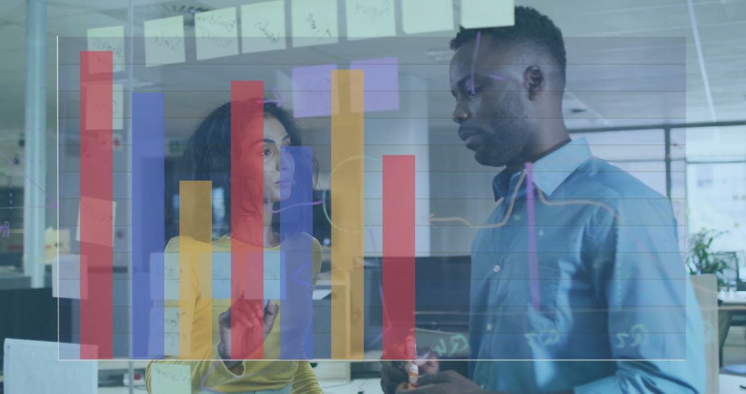 Analysts Collaborating While Reviewing Data Charts in Modern Office