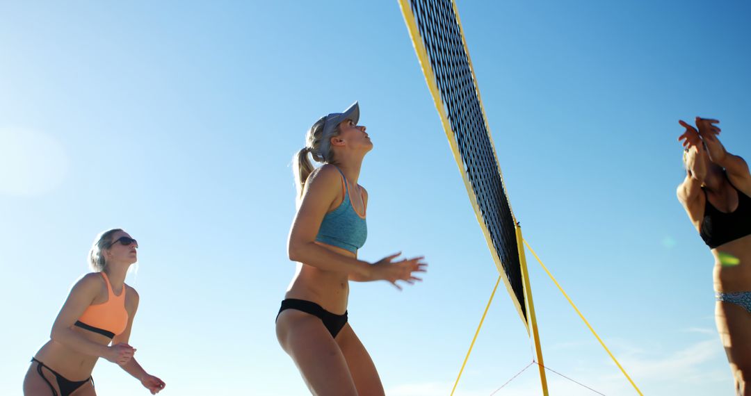 Group of Women Playing Beach Volleyball on Sunny Day - Free Images, Stock Photos and Pictures on Pikwizard.com