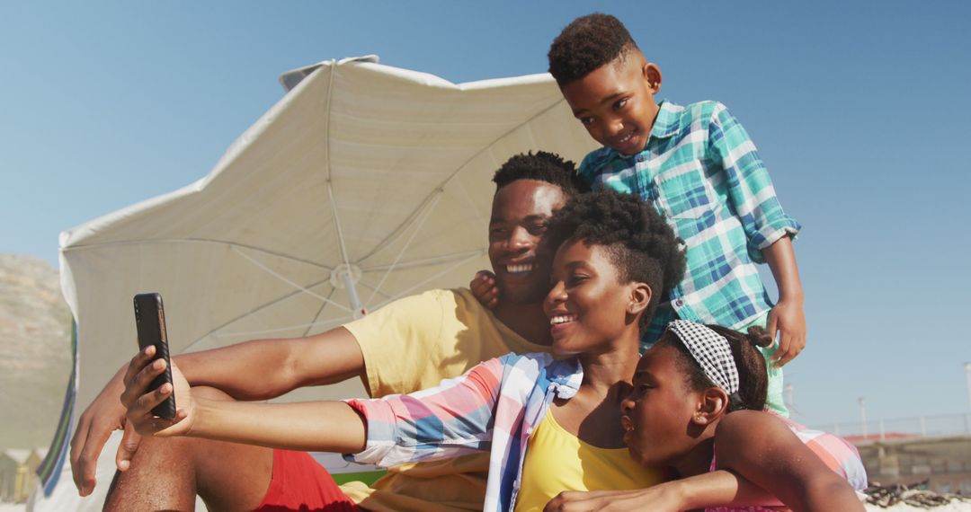 Happy African American family taking selfie on sunny beach vacation - Free Images, Stock Photos and Pictures on Pikwizard.com