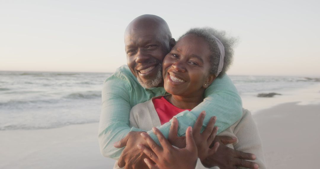 Happy Senior Couple Smiling and Hugging on Beach at Sunset - Free Images, Stock Photos and Pictures on Pikwizard.com