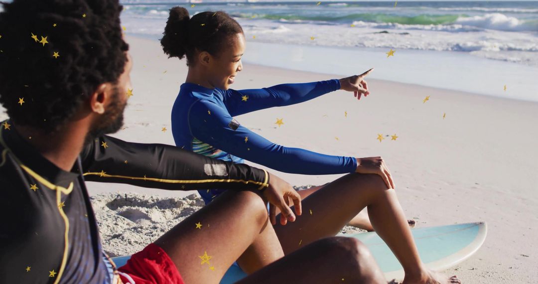 Surf Enthusiasts Relax on Sandy Beach Pointing at Ocean
