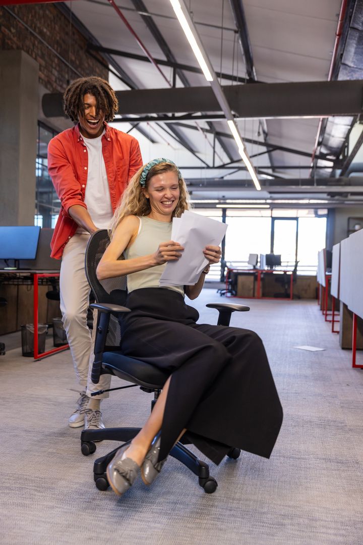 Playful Coworkers Engaging in Fun Activity in Modern Office Space