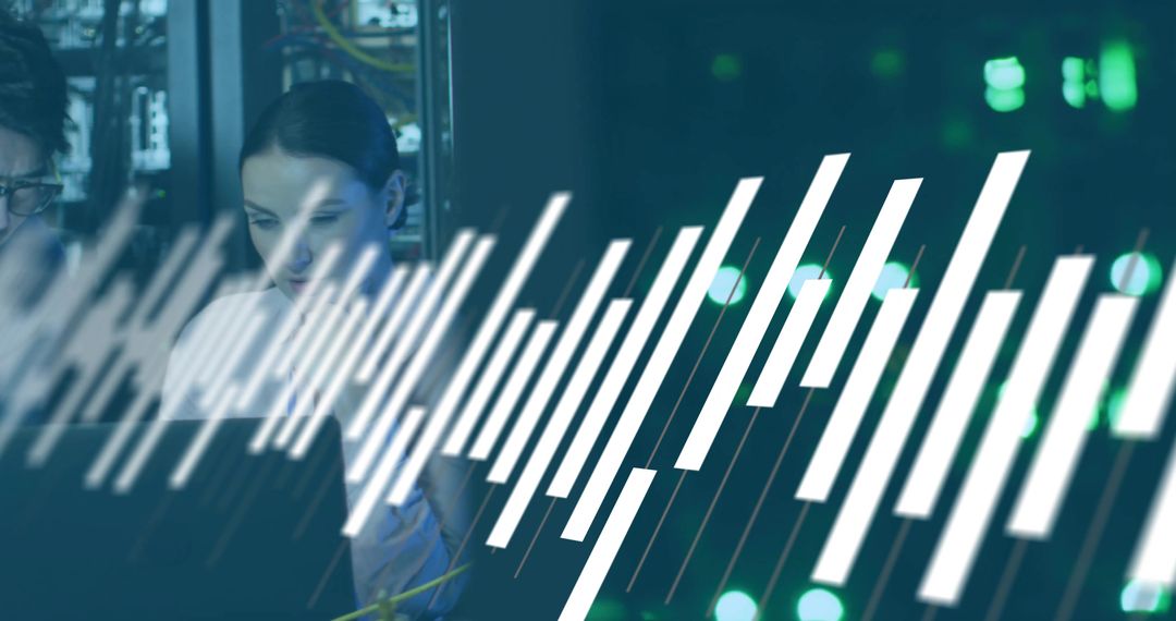 Female Network Technician Monitoring Server Performance Using Laptop with Graph Overlay