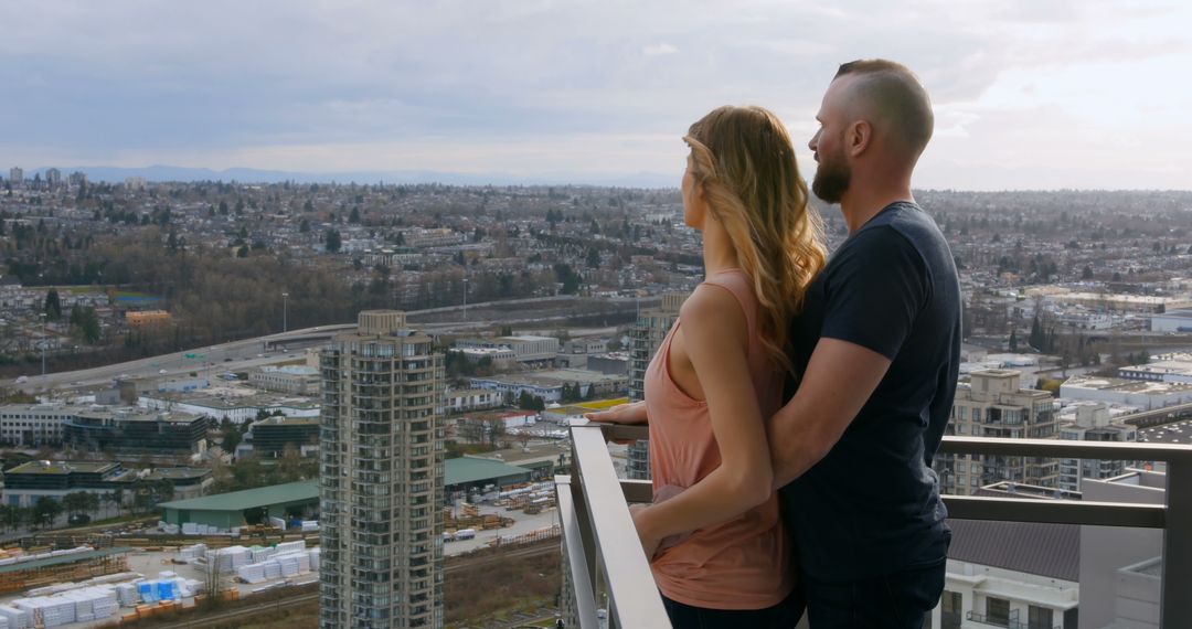 Romantic Couple Overlooking Urban City from Rooftop - Free Images, Stock Photos and Pictures on Pikwizard.com