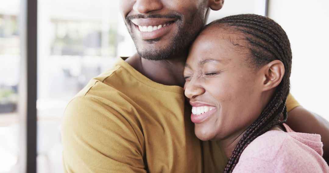 Joyful Afro Couple Embracing in Warm Home Environment