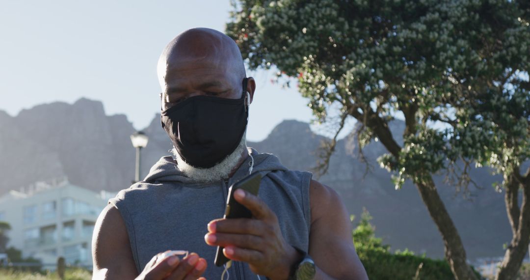 Senior Man Wearing Face Mask Outdoors Using Smartphone - Free Images, Stock Photos and Pictures on Pikwizard.com