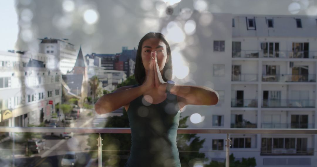 Biracial Woman Practicing Yoga with Dynamic Light Effects on Balcony