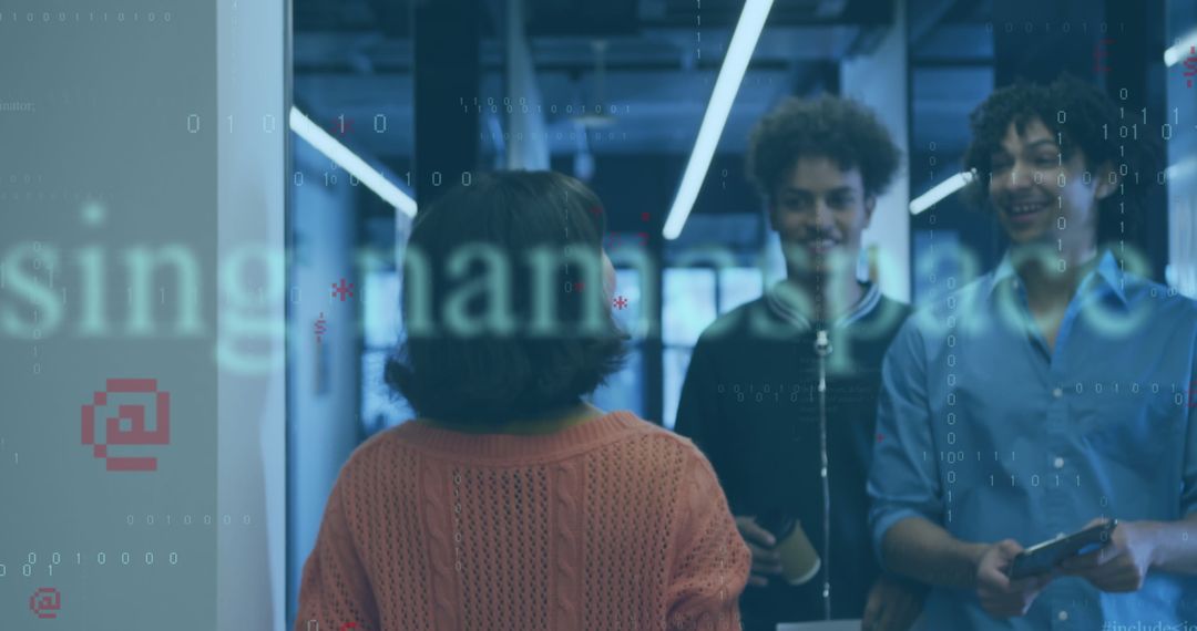 Tech Colleagues Collaborating in Office Hallway