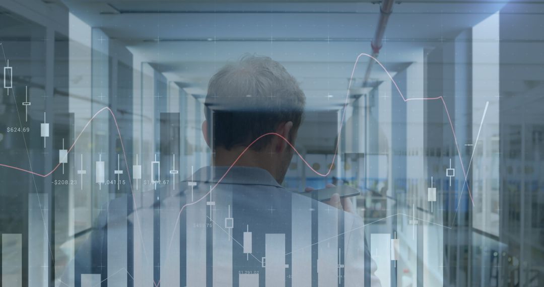 Businessman in Futuristic Office with Financial Graphs Display