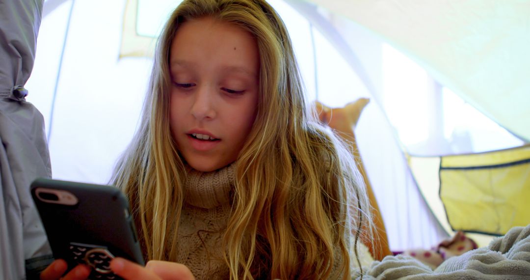 Young Girl Using Smartphone in Tent Indoor Camping - Free Images, Stock Photos and Pictures on Pikwizard.com