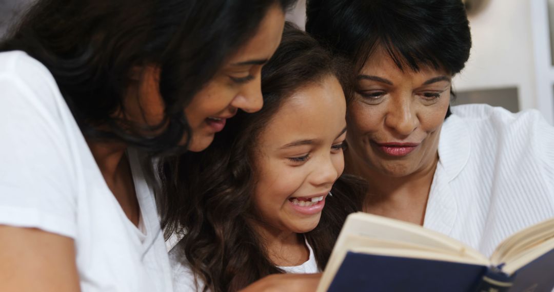 Three Generations of Diverse Women Reading Together and Smiling - Free Images, Stock Photos and Pictures on Pikwizard.com