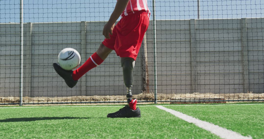 Soccer Player with Prosthetic Leg Kicking Ball on Field - Free Images, Stock Photos and Pictures on Pikwizard.com